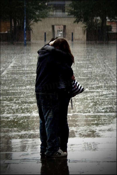 Couple hugging in the rain