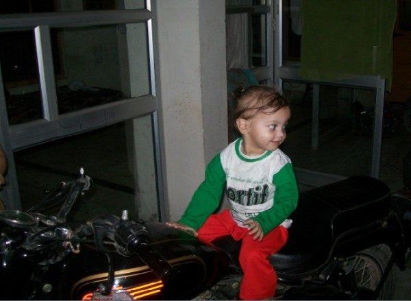 Baby sitting on Royal Enfield, Bullet