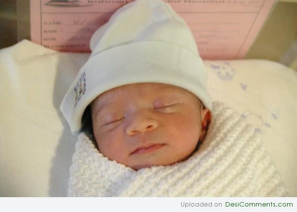 Baby wearing a White Cap