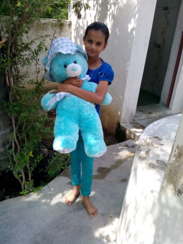 Girl holding a teddy bear