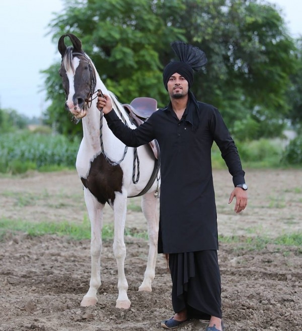 Garry Sandhu Posing With Horse