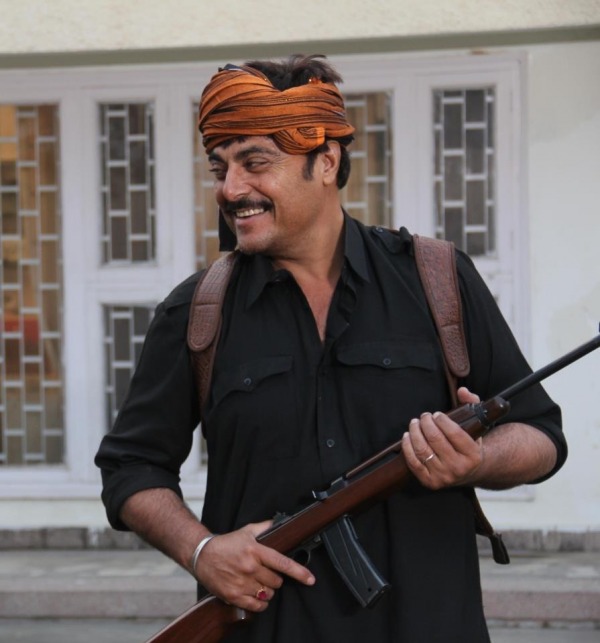 Guggu Gill Holding Gun