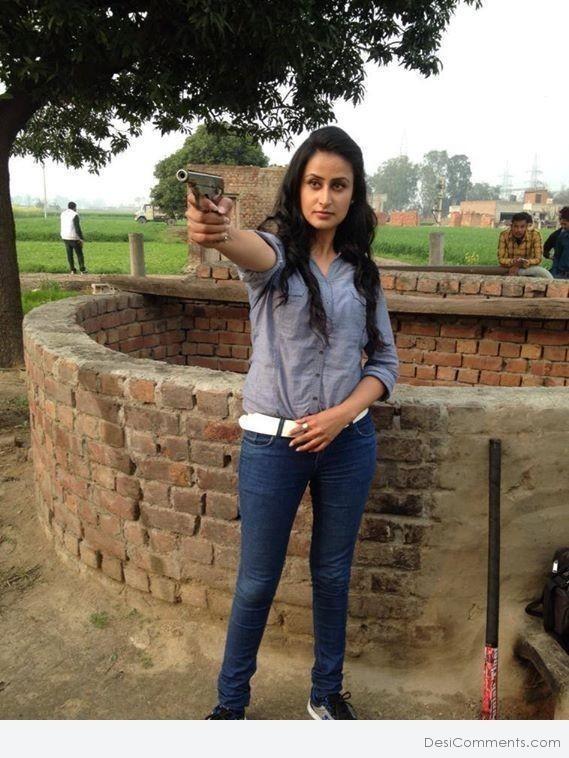 Jaspinder Cheema Holding Gun