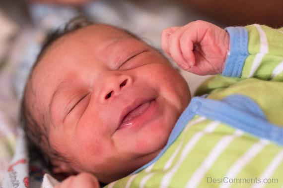 Baby Boy Smiling While Sleeping