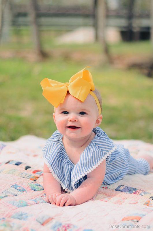 Baby In Yellow Bow