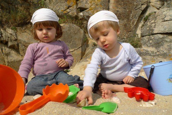 Babies Playing At Beach