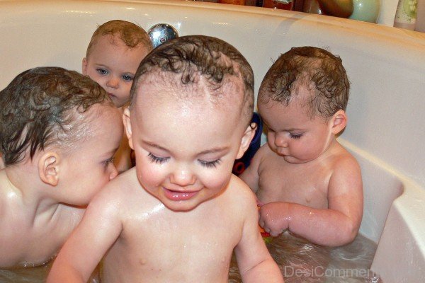 Babies Playing In Bath Tub