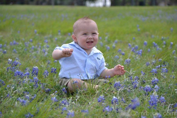 Baby Boy Sitting In Flowers
