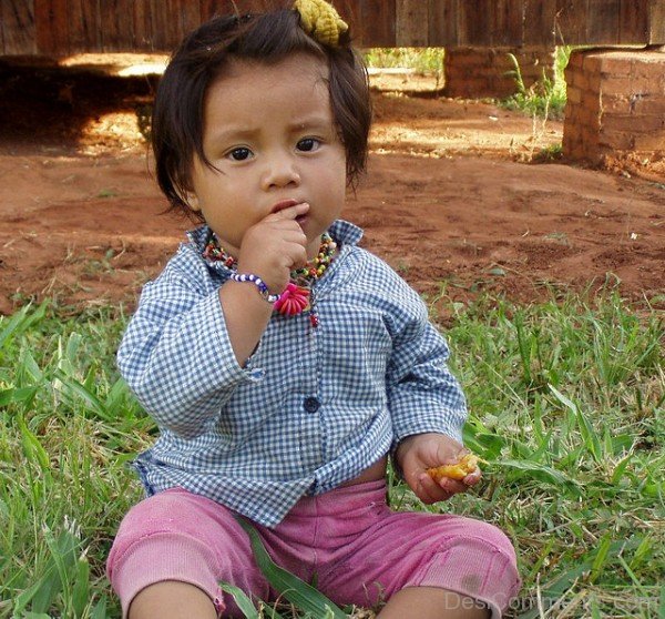 Baby Girl Sitting On Grass