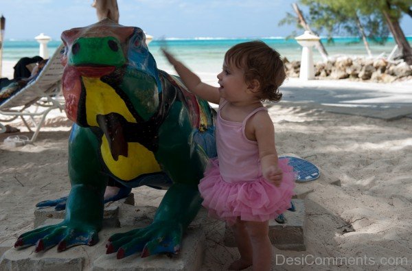 Baby Girl Touching Statue