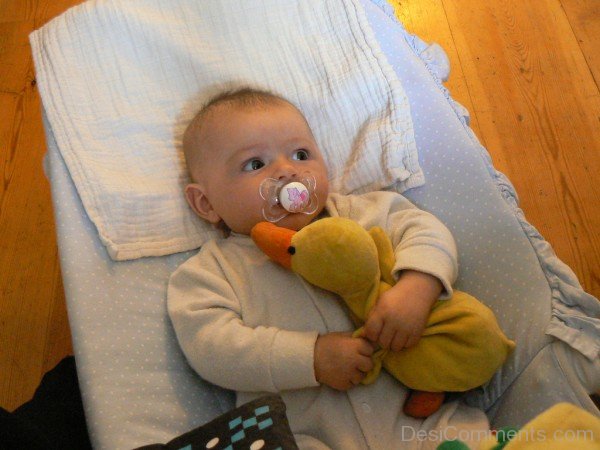 Baby Holding Duck Toy