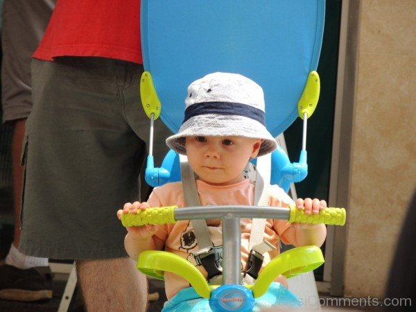 Baby Sitting On His Toy Bicycle