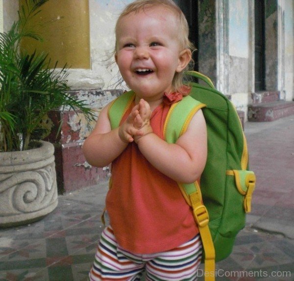Baby Wearing School Bag And Laughing