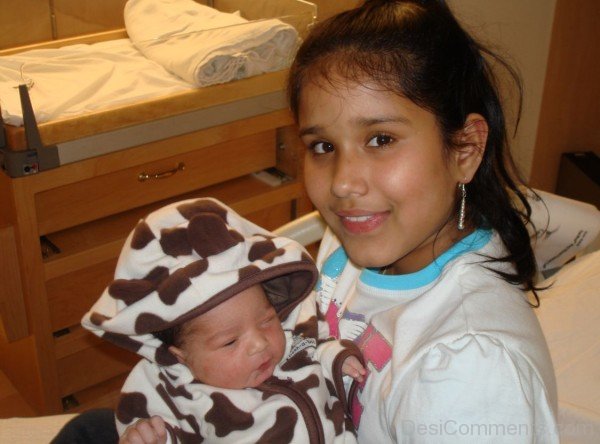 Girl Holding Newborn Baby