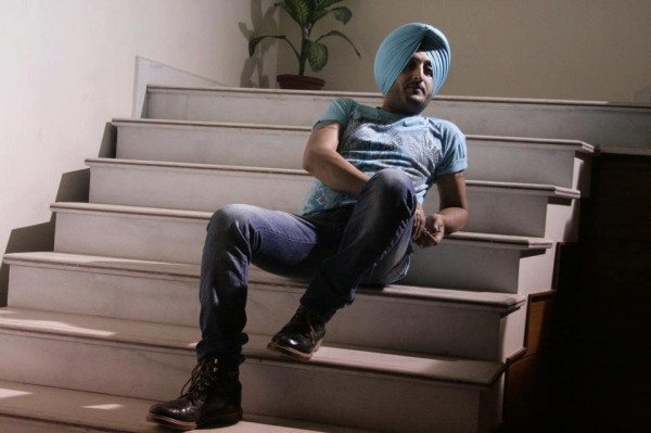 Inderjit Nikku Sitting On Stairs