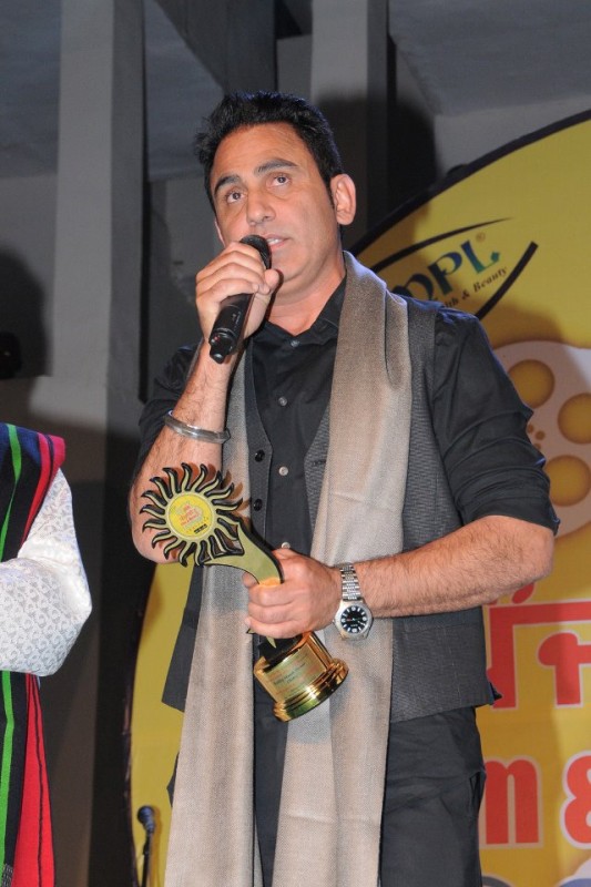Sarbjit Cheema Holding An Award
