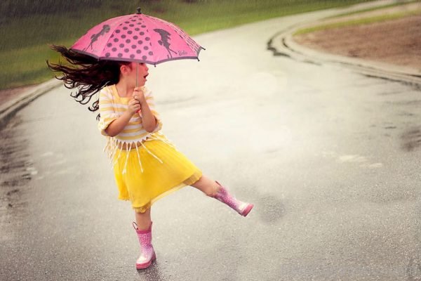 Sweet Little Girl Enjoying Rain